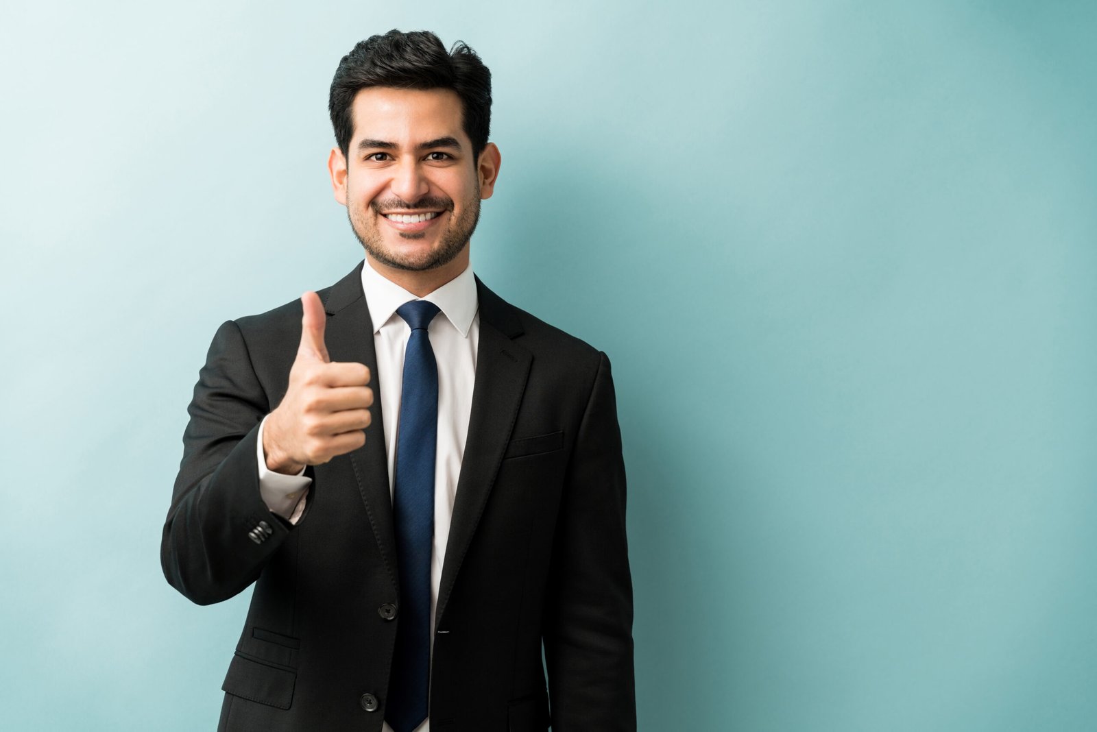 portrait of businessman showing hand sign in studio